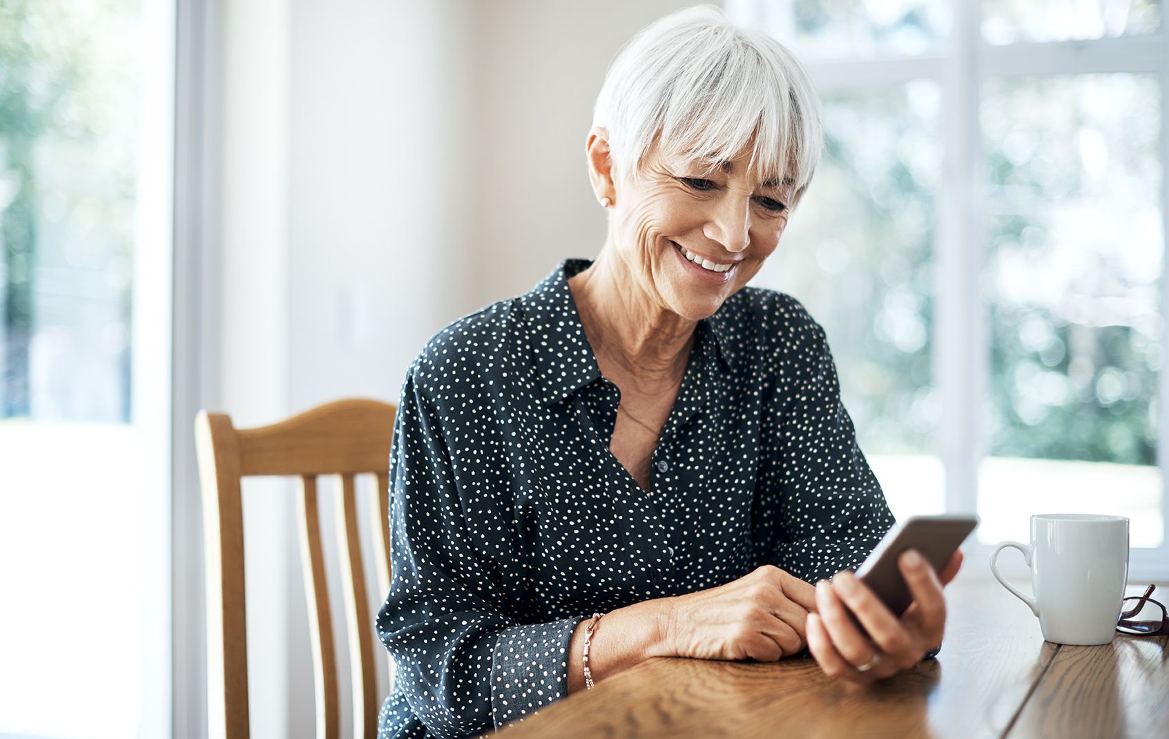 Close-up of person using phone to use electric co-op app